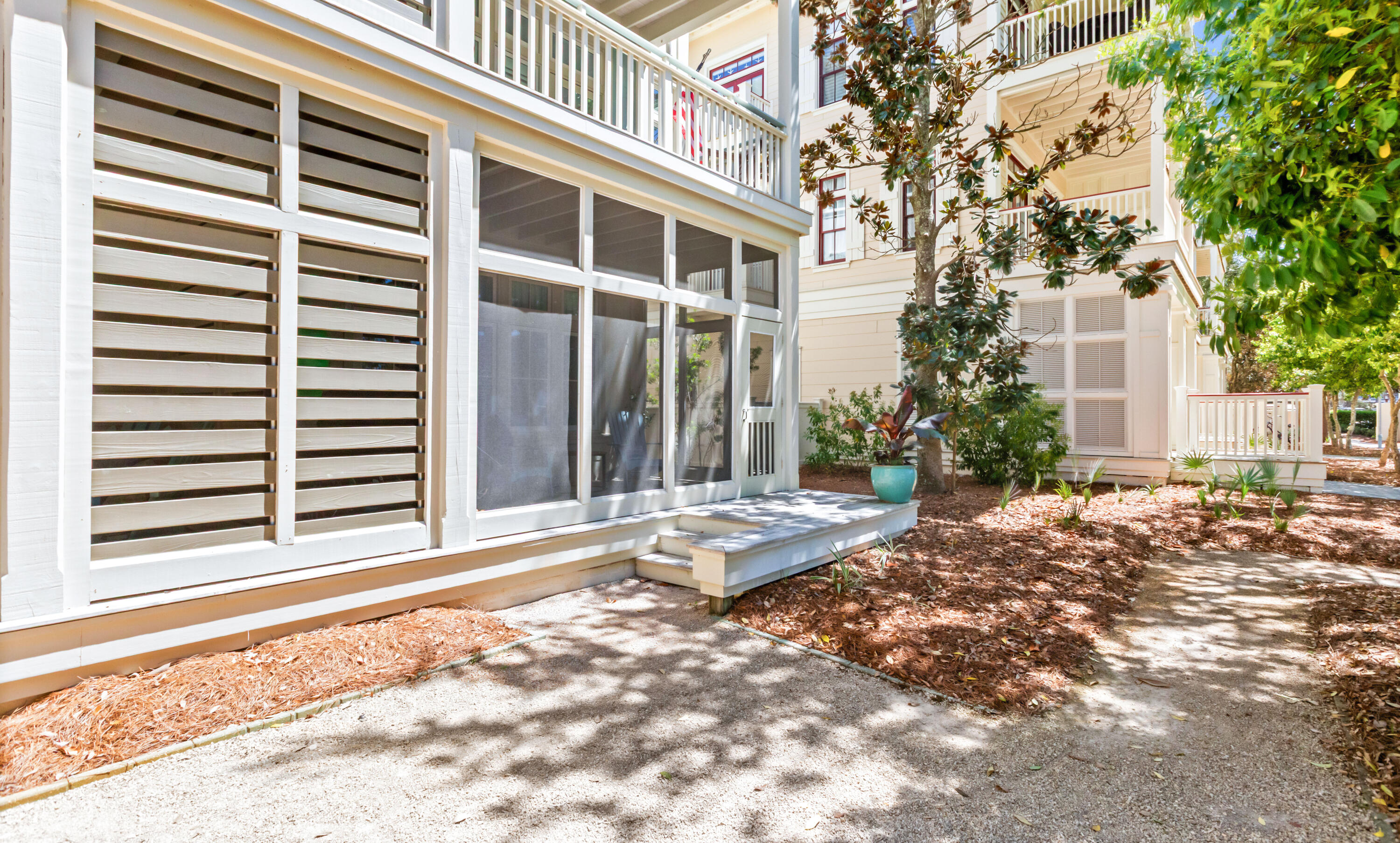 1660 East County Highway 30A, Unit 101 Santa Rosa Beach, FL 32459 - Photo 52 of 67 a view of a house with a small yard and the tree