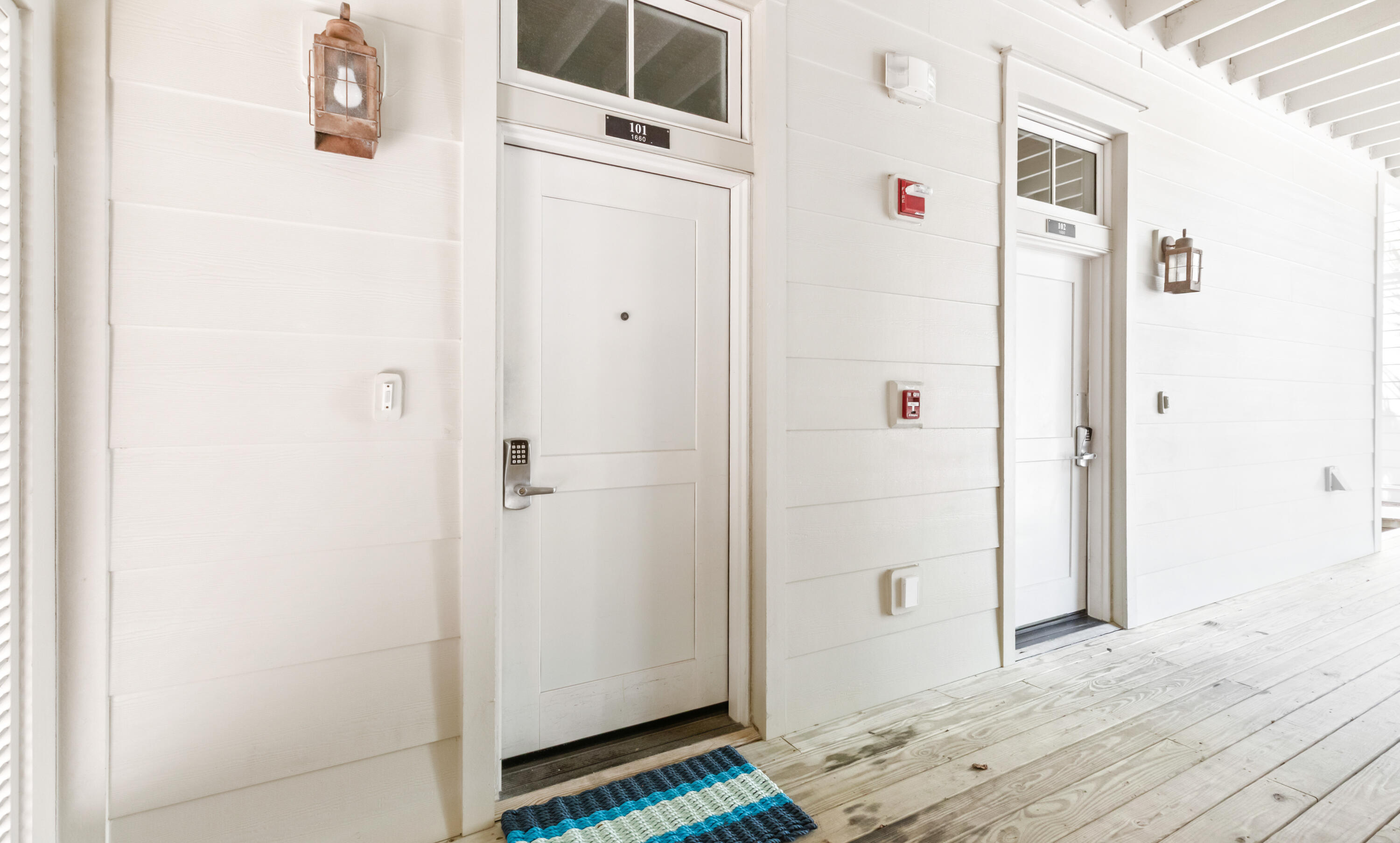 1660 East County Highway 30A, Unit 101 Santa Rosa Beach, FL 32459 - Photo 57 of 67 a view of a hallway with wooden floor and entryway