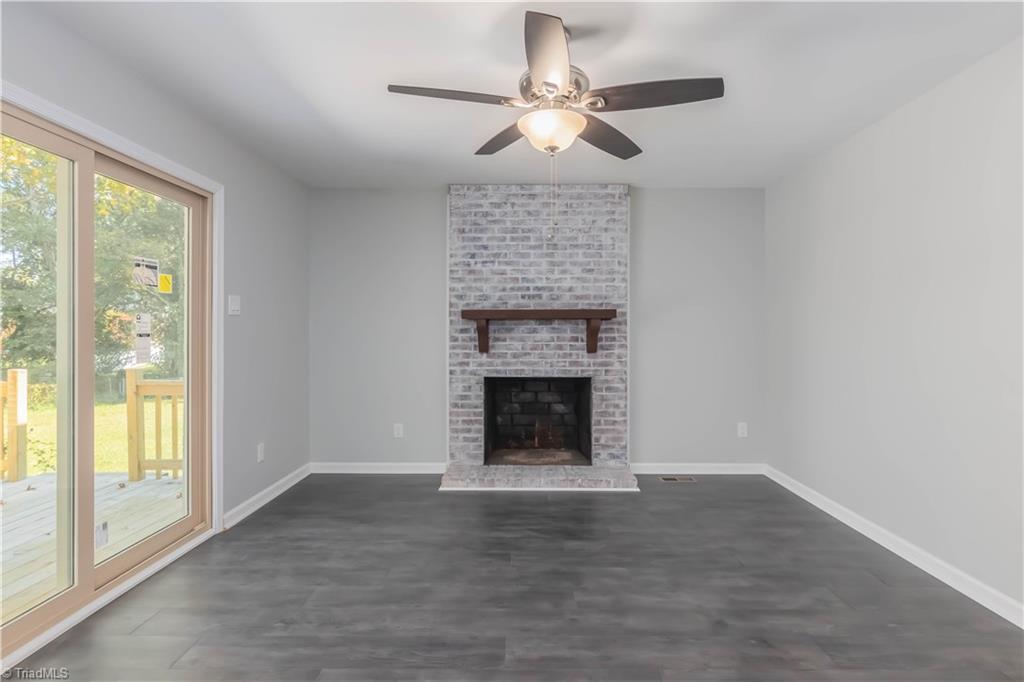 3206 Dillon Road Jamestown, NC 27282 - Photo 15 of 30 Den with remodeled fireplace with backyard views and a new sliding door accessing the back deck.