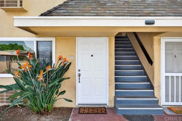 a view of staircase with wooden floor and a potted plant