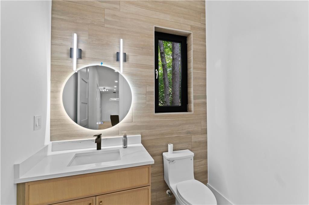 2695 Collins Hill Road Lawrenceville, GA 30043 - Photo 13 of 66 a bathroom with a toilet sink and mirror