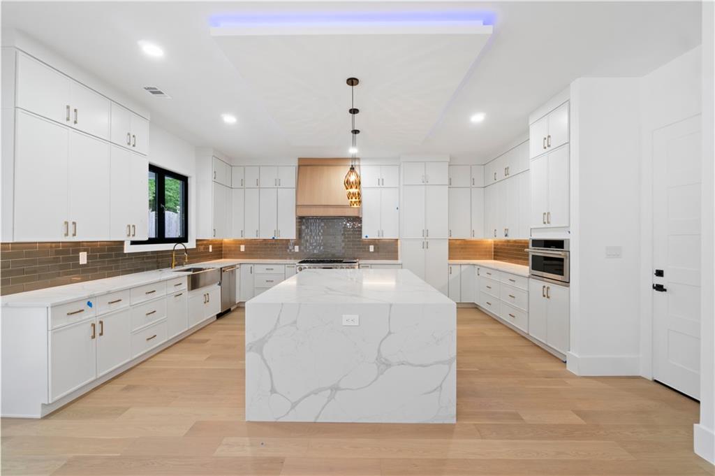 2695 Collins Hill Road Lawrenceville, GA 30043 - Photo 18 of 66 a large white kitchen with cabinets
