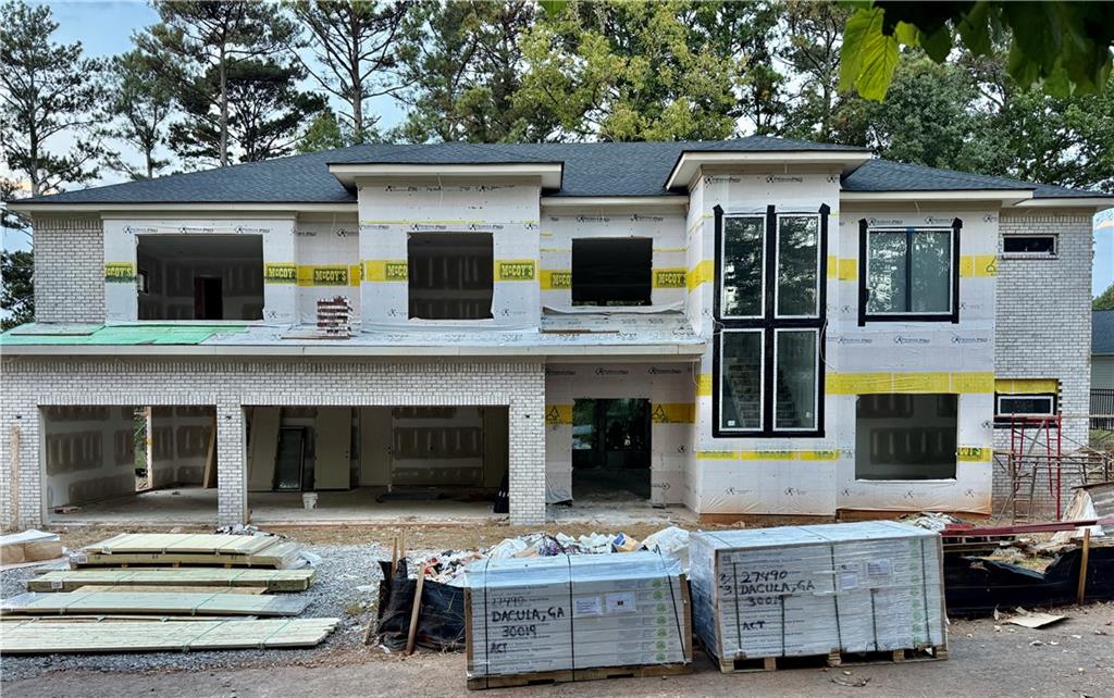 2695 Collins Hill Road Lawrenceville, GA 30043 - Photo 2 of 66 a view of a white house with large windows and a fireplace