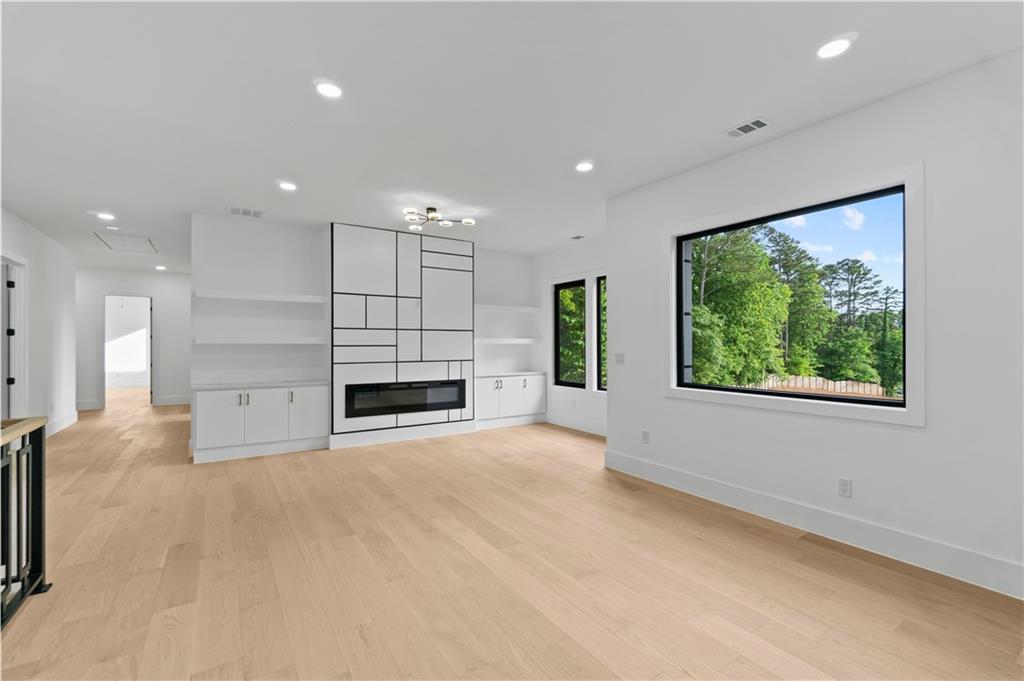 2695 Collins Hill Road Lawrenceville, GA 30043 - Photo 27 of 66 a view of an empty room with a fireplace and a window