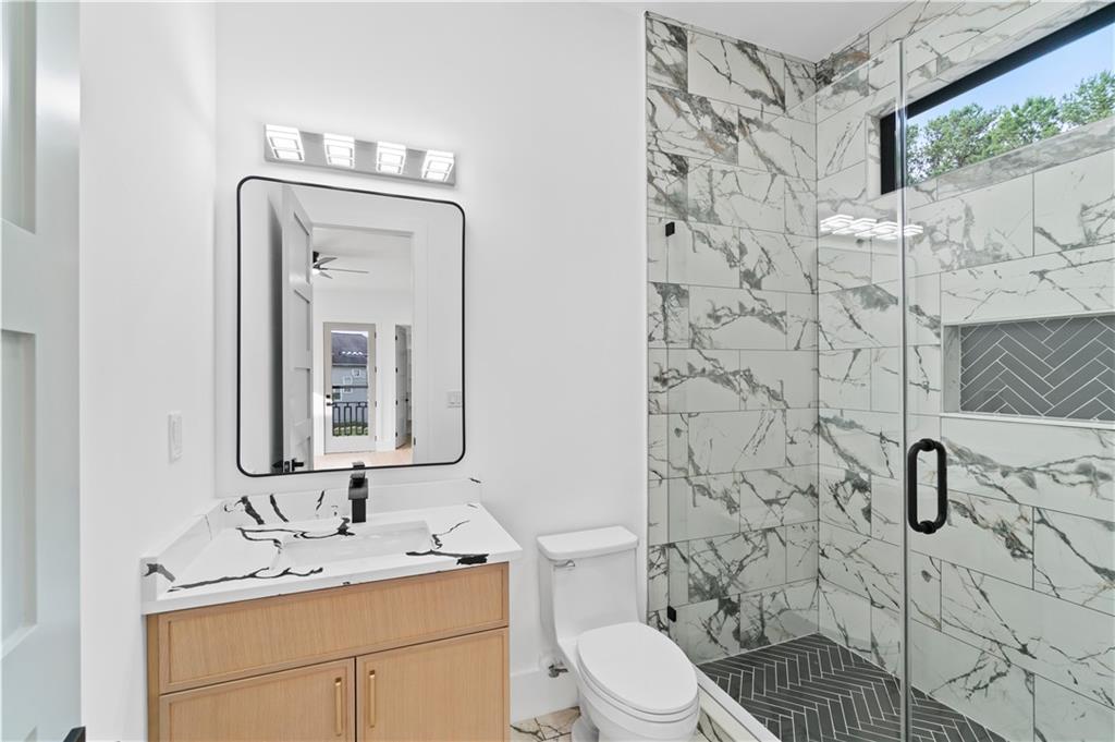 2695 Collins Hill Road Lawrenceville, GA 30043 - Photo 34 of 66 a bathroom with a toilet sink shower and mirror