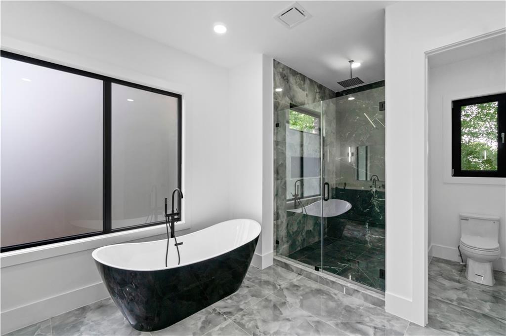 2695 Collins Hill Road Lawrenceville, GA 30043 - Photo 56 of 66 a bathroom with a toilet a sink and mirror