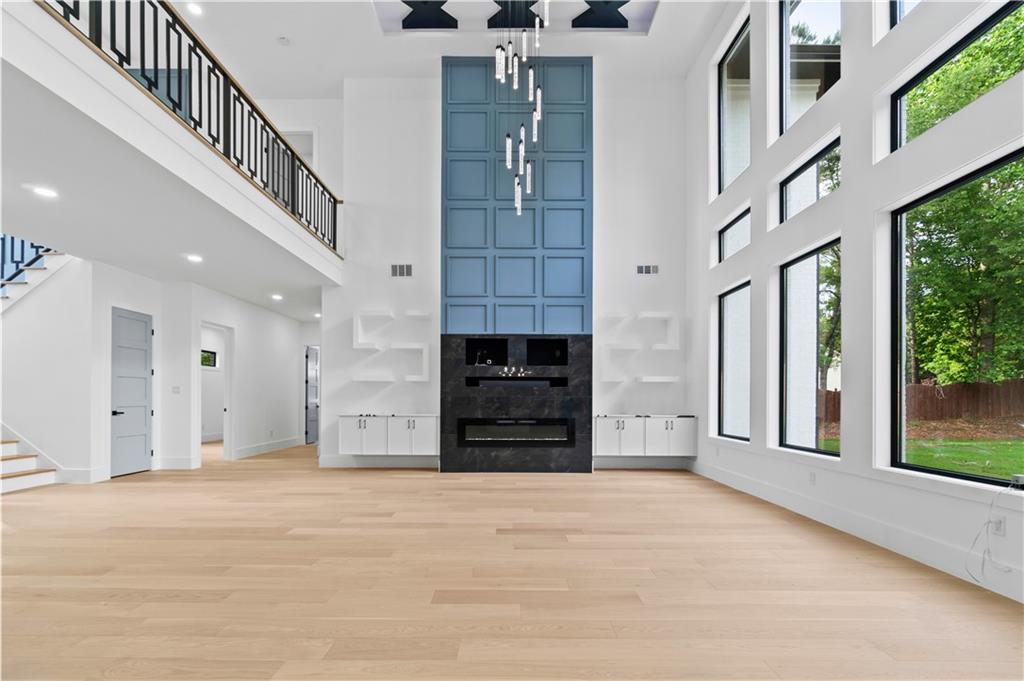 2695 Collins Hill Road Lawrenceville, GA 30043 - Photo 10 of 66 wooden floor in an empty room with a fireplace and a window