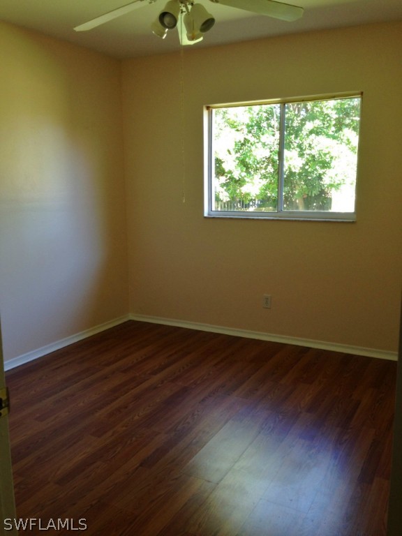 9147 Aster Road Fort Myers, FL 33967 - Photo 17 of 20 an empty room with wooden floor and windows