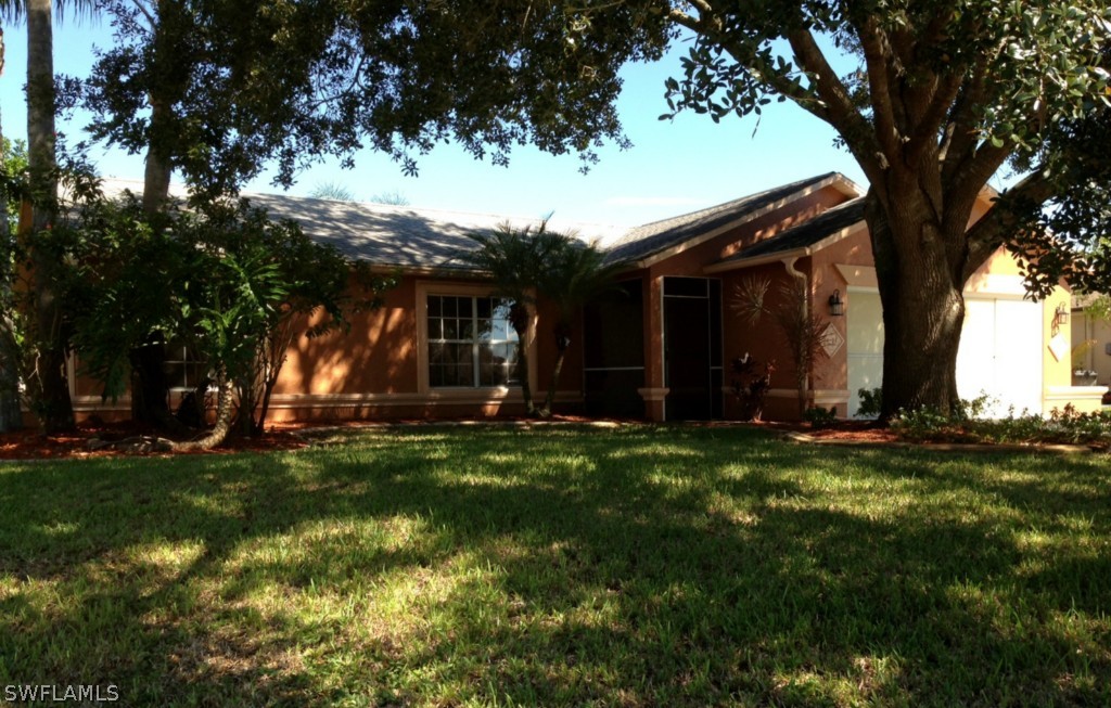9147 Aster Road Fort Myers, FL 33967 - Photo 2 of 20 a view of a backyard with large trees