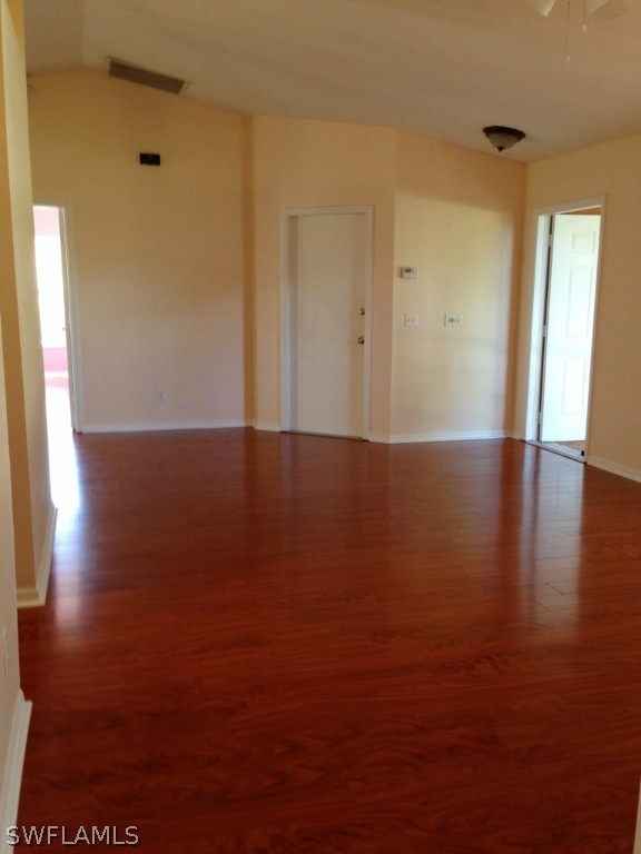 9147 Aster Road Fort Myers, FL 33967 - Photo 7 of 20 a view of an empty room with wooden floor and a window