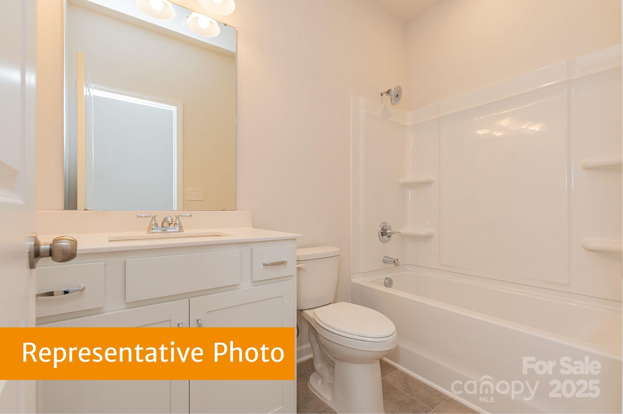 6037 Jasmine Br Road Charlotte, NC 28216 - Photo 27 of 33 a bathroom with a sink a toilet and shower