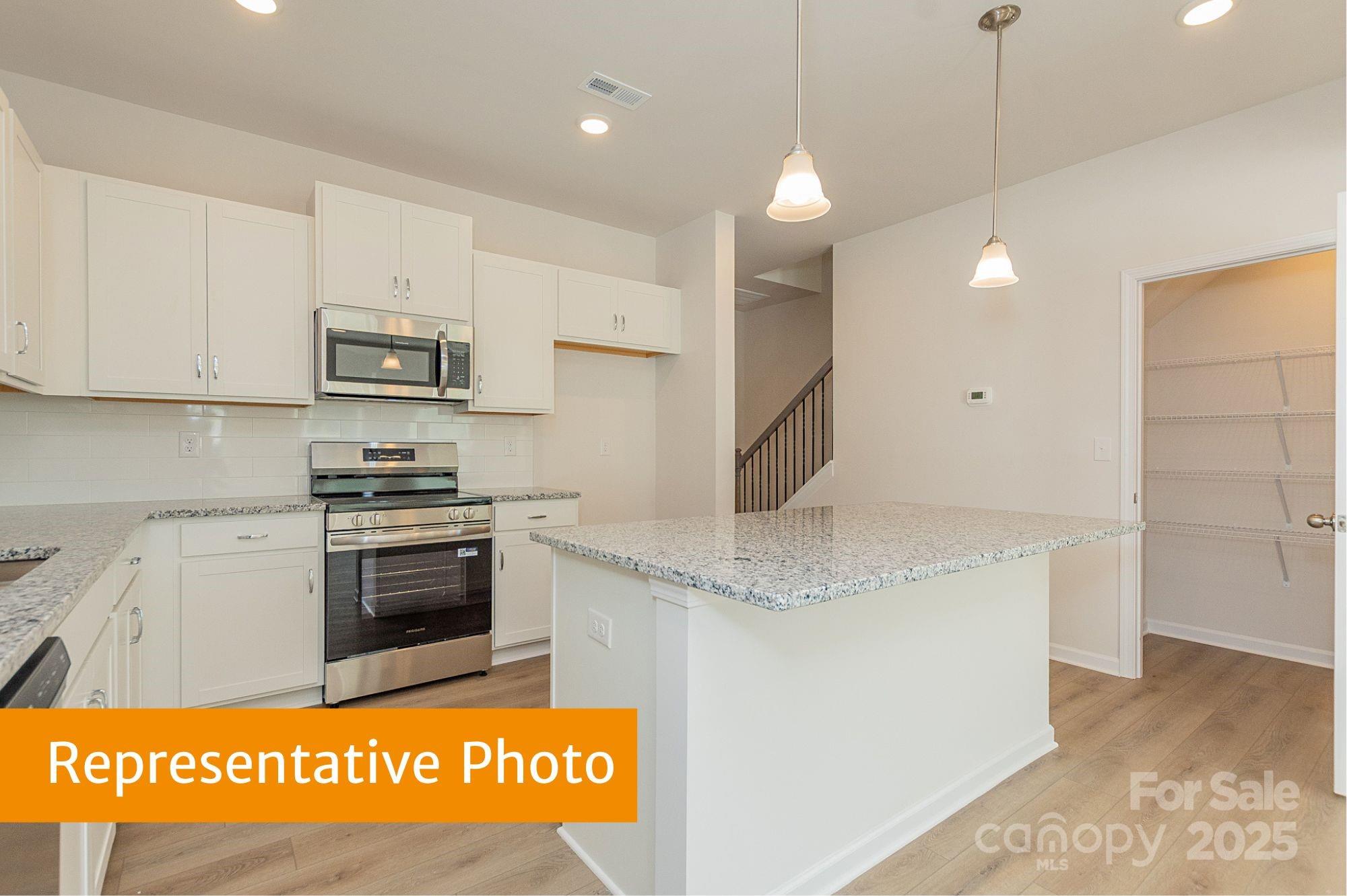 6037 Jasmine Br Road Charlotte, NC 28216 - Photo 5 of 33 a kitchen with stainless steel appliances granite countertop a sink and a stove