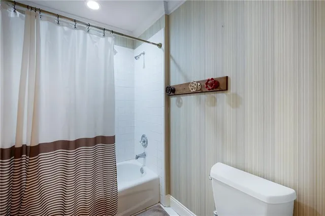 a view of backyard with seating space and wooden fence