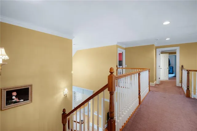 a kitchen with stainless steel appliances a sink a stove and white cabinets