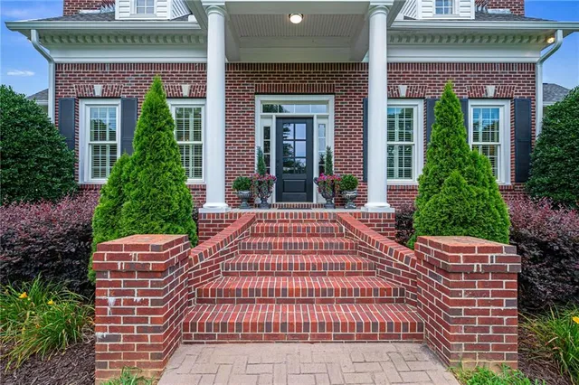 an aerial view of a house with swimming pool outdoor seating and yard