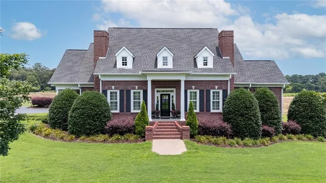 a aerial view of a house with swimming pool yard and outdoor seating