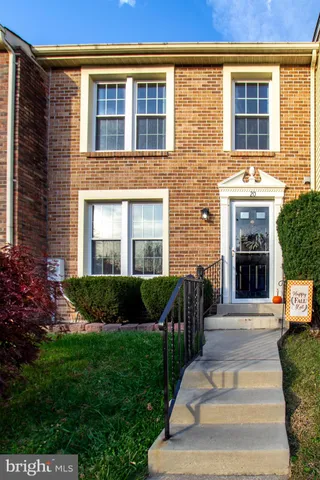 a front view of a house with a yard and outdoor seating
