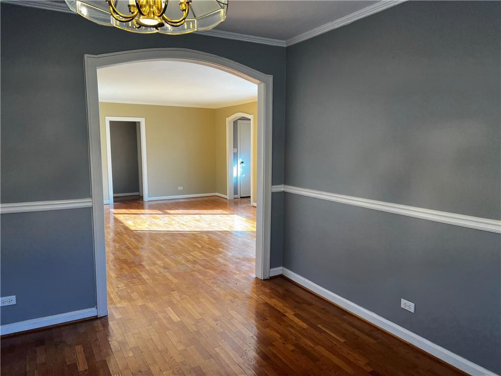 606 Pisgah Way Calhoun, GA 30701 - Photo 9 of 18 an empty room with wooden floor and chandelier