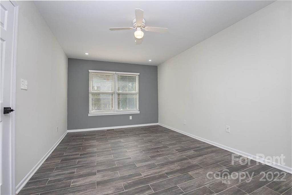 9501 Fairway Ridge Road Charlotte, NC 28277 - Photo 14 of 26 wooden floor in an empty room with a window