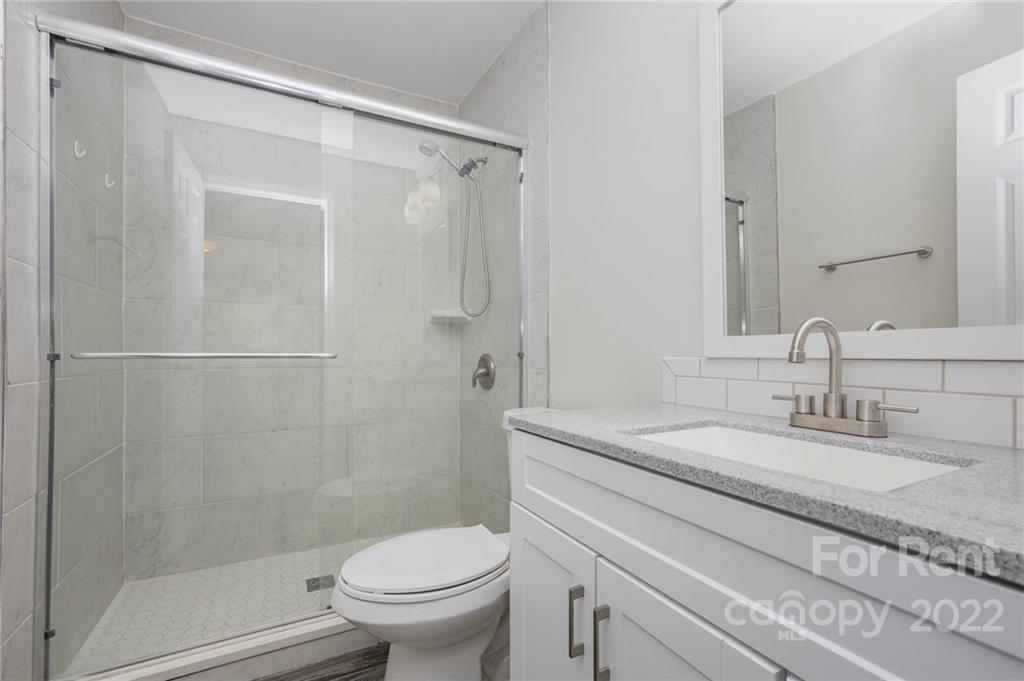 9501 Fairway Ridge Road Charlotte, NC 28277 - Photo 16 of 26 a bathroom with a granite countertop sink toilet and shower