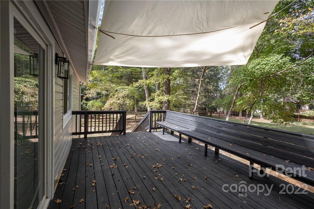 9501 Fairway Ridge Road Charlotte, NC 28277 - Photo 3 of 26 a balcony with wooden floor table and chairs