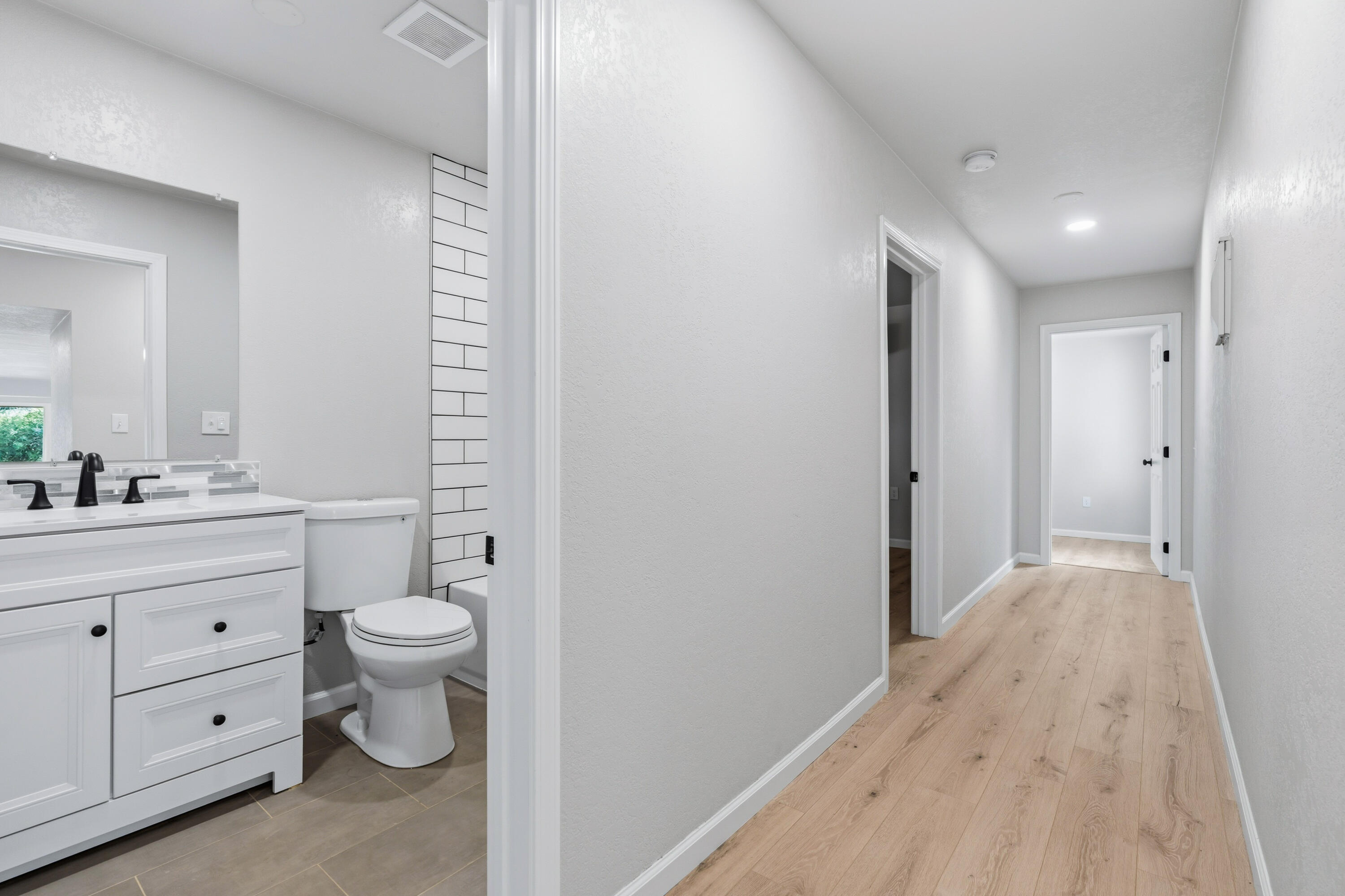 6673 Mountain View Drive Anderson, CA 96007 - Photo 15 of 42 a bathroom with a sink a toilet a large mirror and vanity