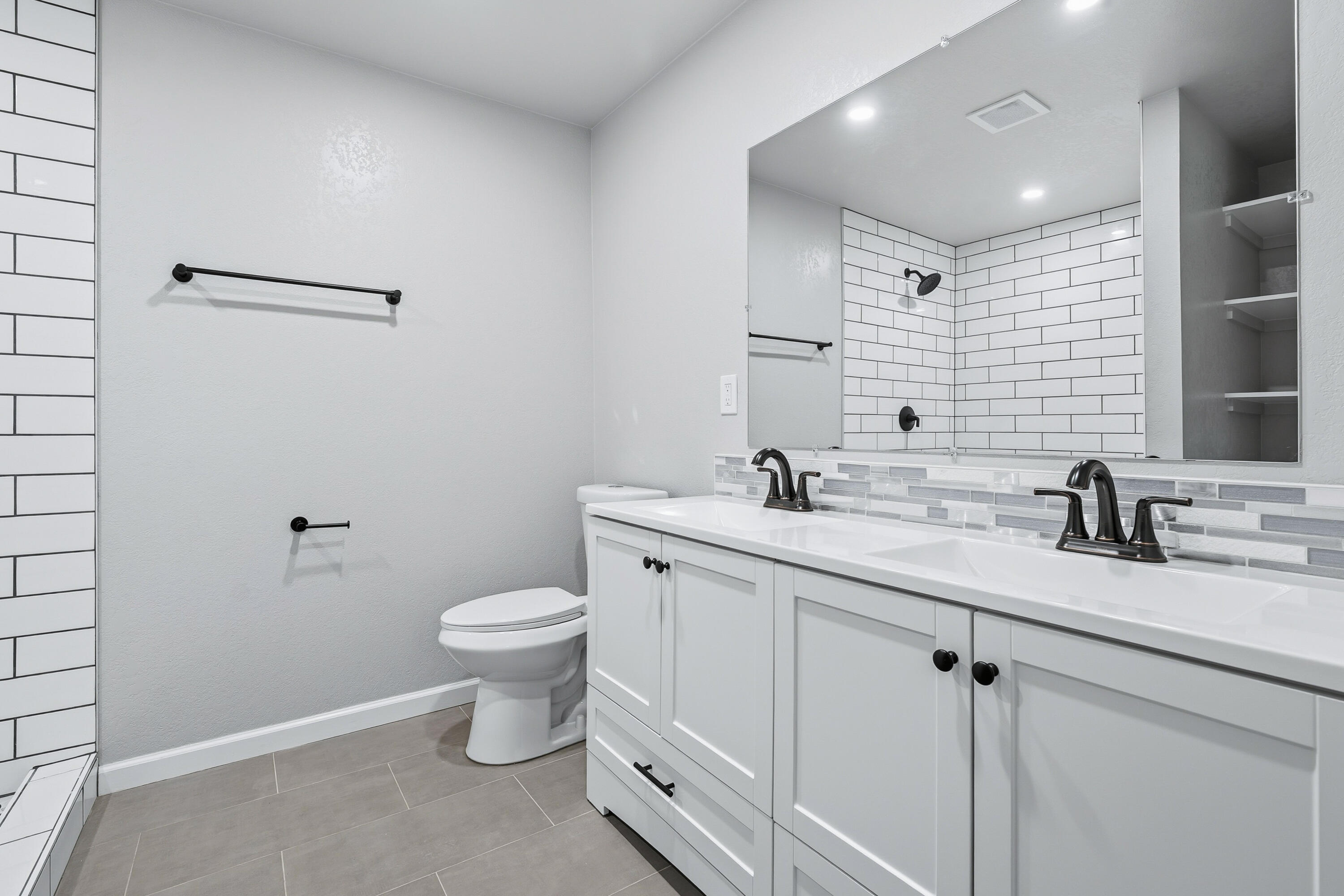 6673 Mountain View Drive Anderson, CA 96007 - Photo 18 of 42 a bathroom with a granite countertop sink a toilet and a mirror