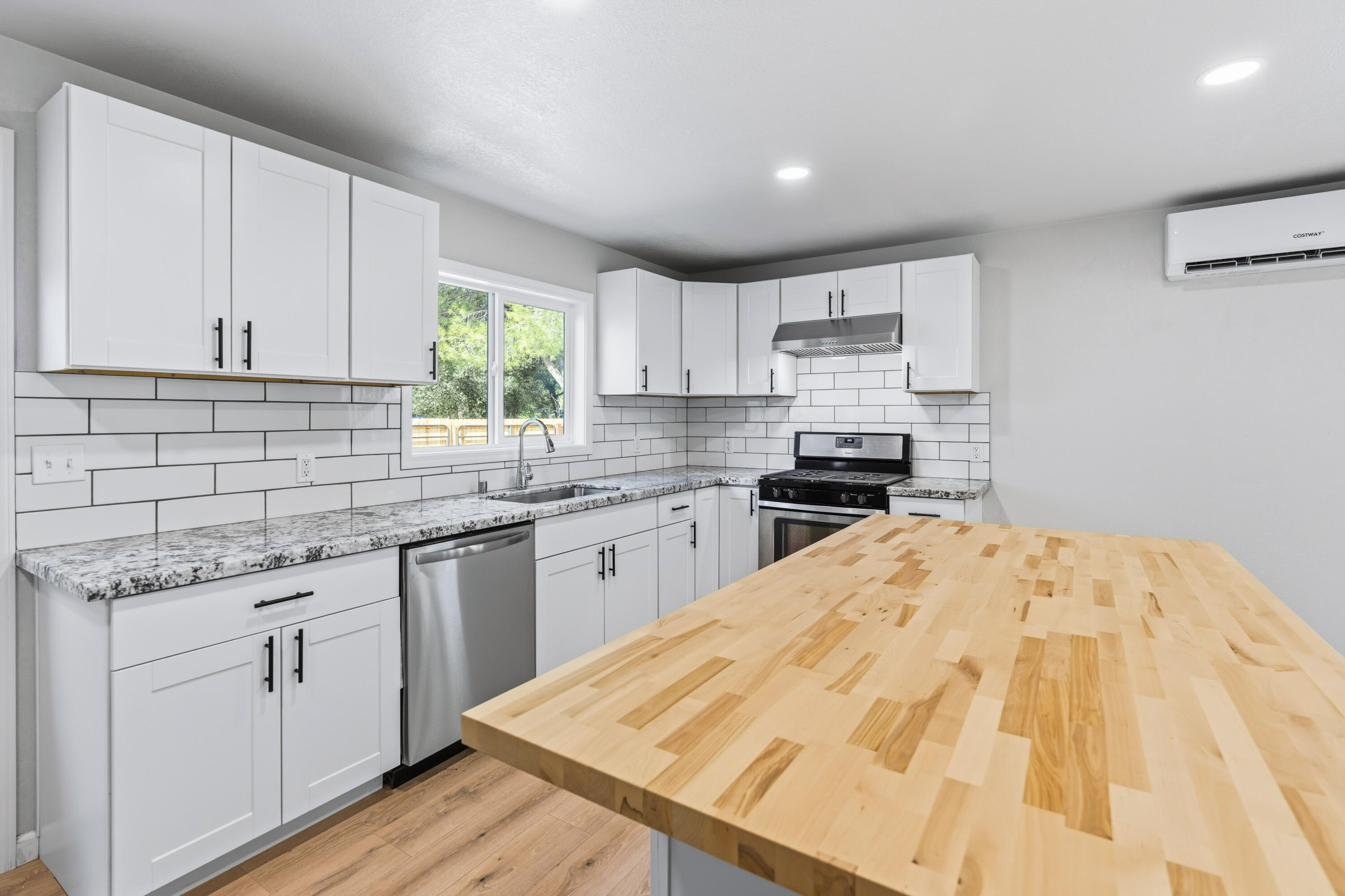 6673 Mountain View Drive Anderson, CA 96007 - Photo 24 of 42 a kitchen with granite countertop a sink stove and cabinets