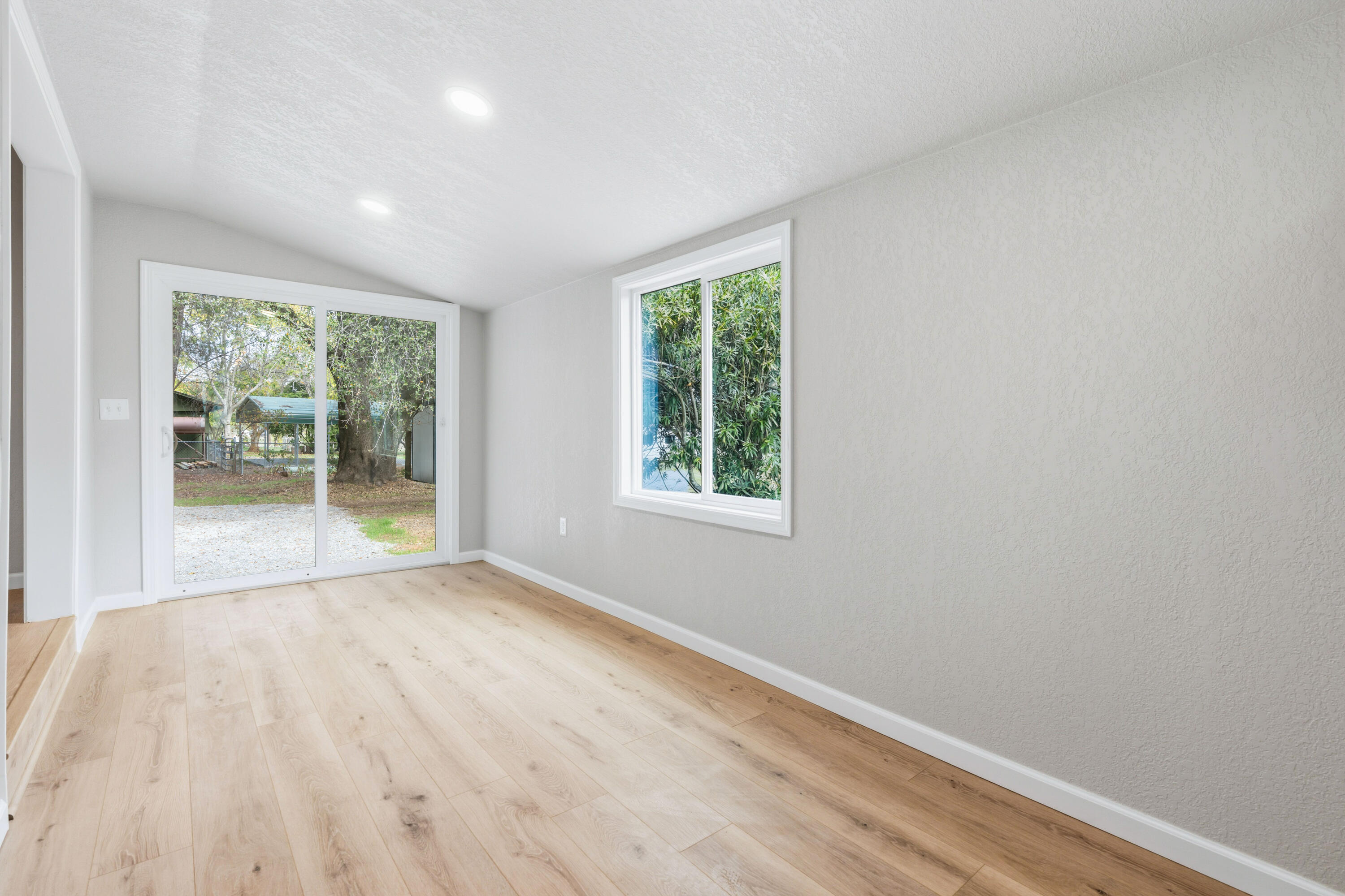 6673 Mountain View Drive Anderson, CA 96007 - Photo 30 of 42 a view of an empty room with wooden floor and a window