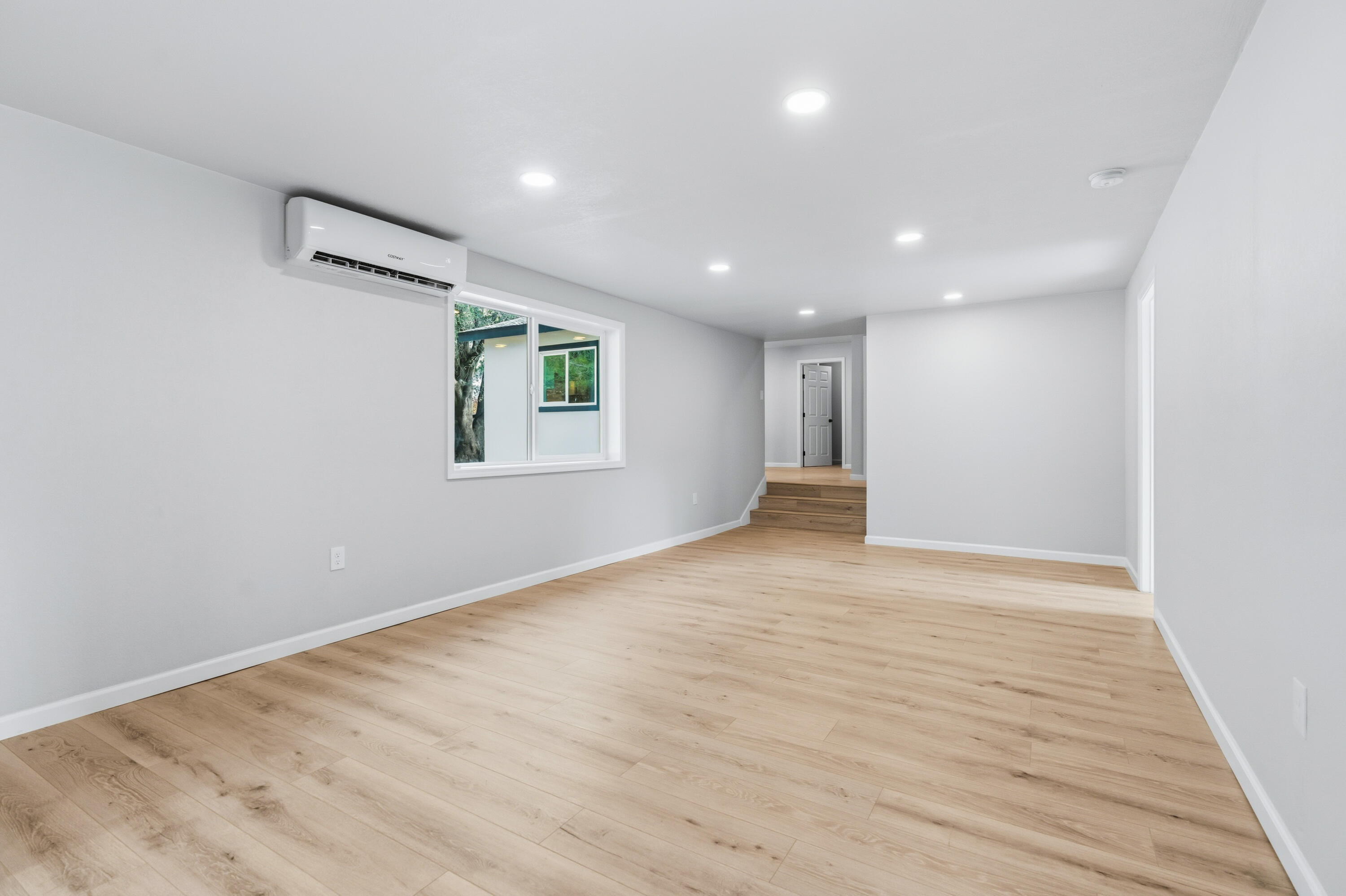 6673 Mountain View Drive Anderson, CA 96007 - Photo 6 of 42 a view of an empty room with wooden floor and a window