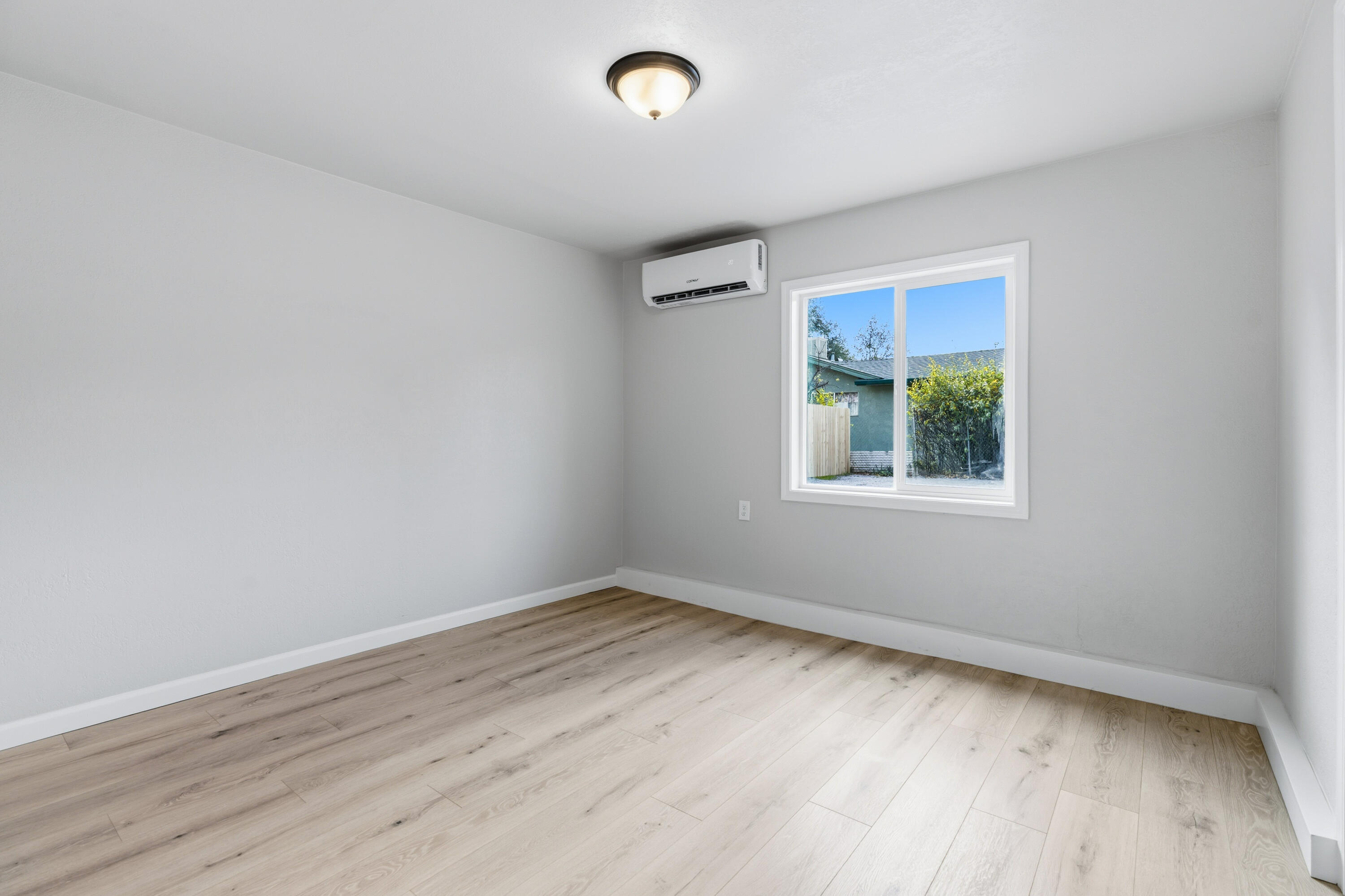 6673 Mountain View Drive Anderson, CA 96007 - Photo 8 of 42 an empty room with wooden floor and windows