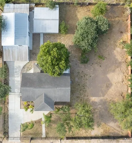 an aerial view of a house with a yard and a garage