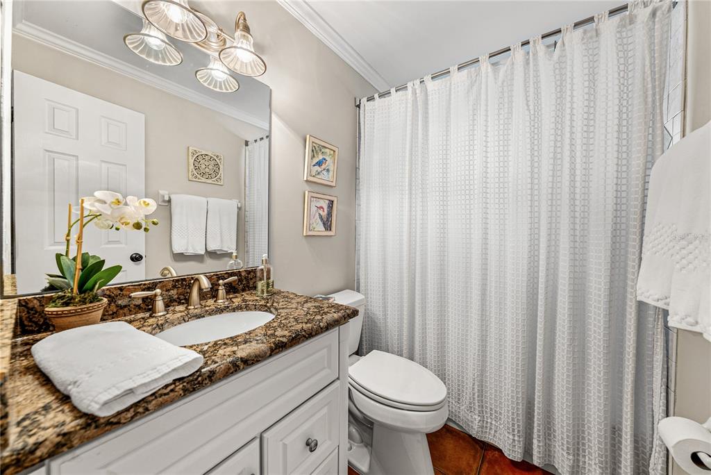 1075 Cody Cove Road Babson Park, FL 33827 - Photo 25 of 96 a bathroom with a granite countertop sink a toilet and a mirror