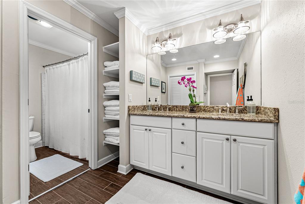 1075 Cody Cove Road Babson Park, FL 33827 - Photo 47 of 96 a bathroom with a granite countertop sink a mirror and a shower