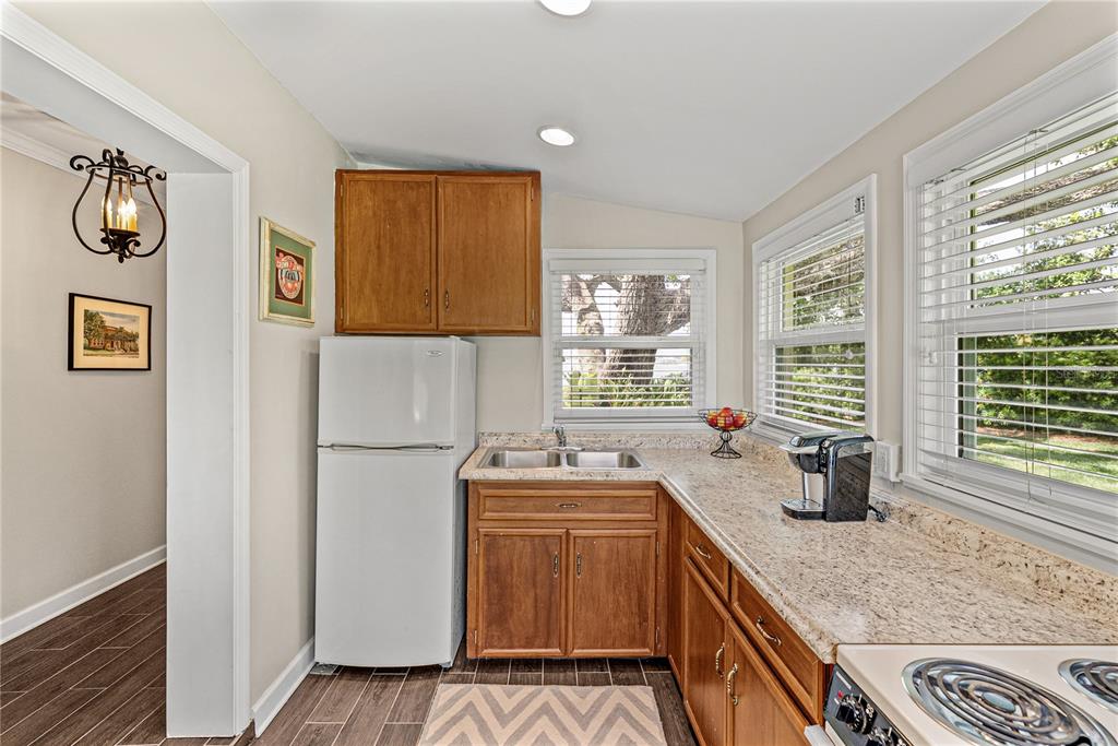 1075 Cody Cove Road Babson Park, FL 33827 - Photo 51 of 96 a kitchen with stainless steel appliances granite countertop a sink stove and refrigerator