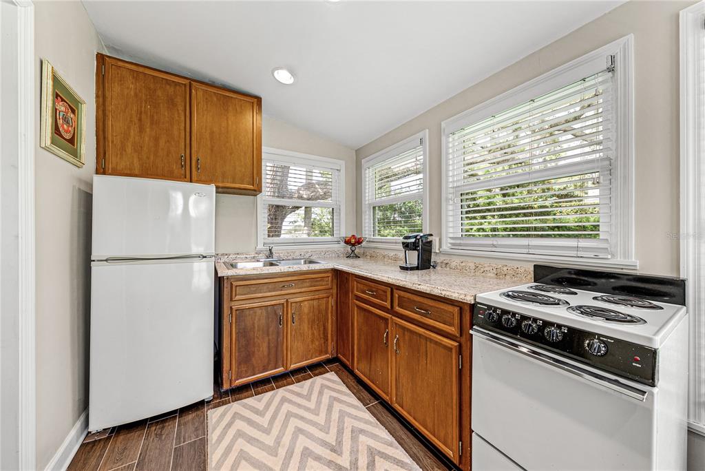 1075 Cody Cove Road Babson Park, FL 33827 - Photo 52 of 96 a kitchen with a refrigerator a stove a sink dishwasher and wooden cabinets