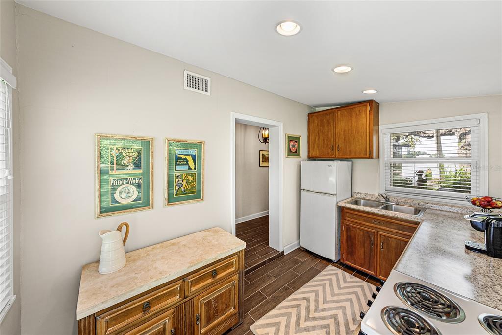 1075 Cody Cove Road Babson Park, FL 33827 - Photo 53 of 96 a kitchen with a refrigerator and a stove top oven