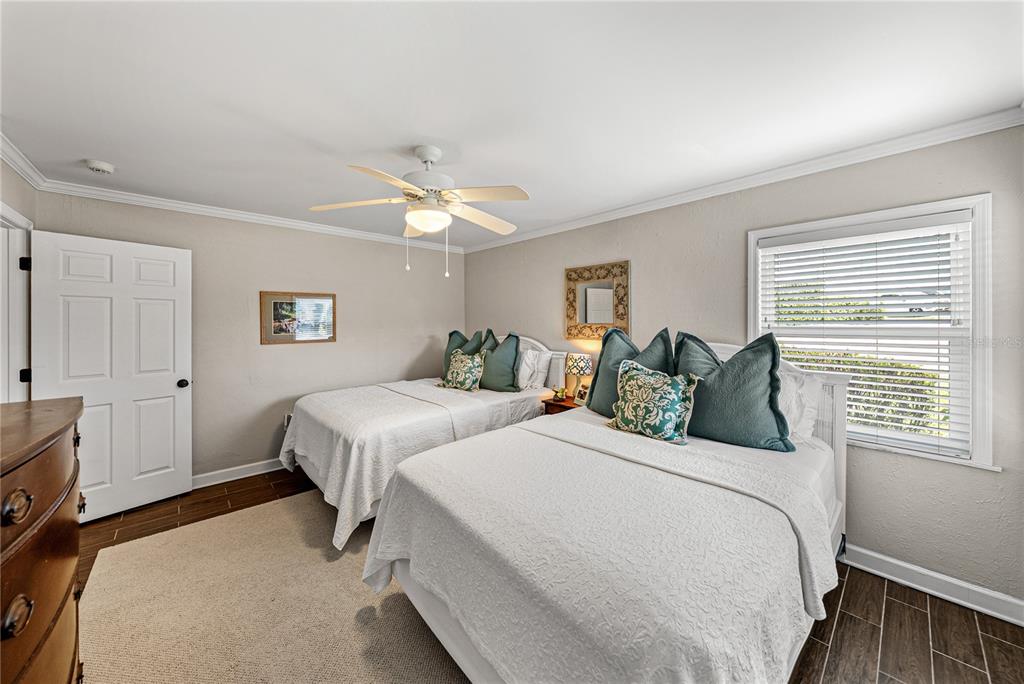 1075 Cody Cove Road Babson Park, FL 33827 - Photo 56 of 96 a bedroom with two beds and a chandelier