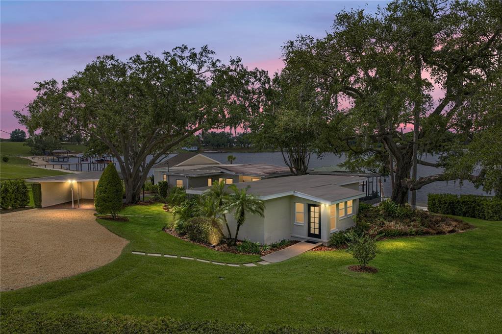 1075 Cody Cove Road Babson Park, FL 33827 - Photo 93 of 96 a front view of a house with a garden and trees