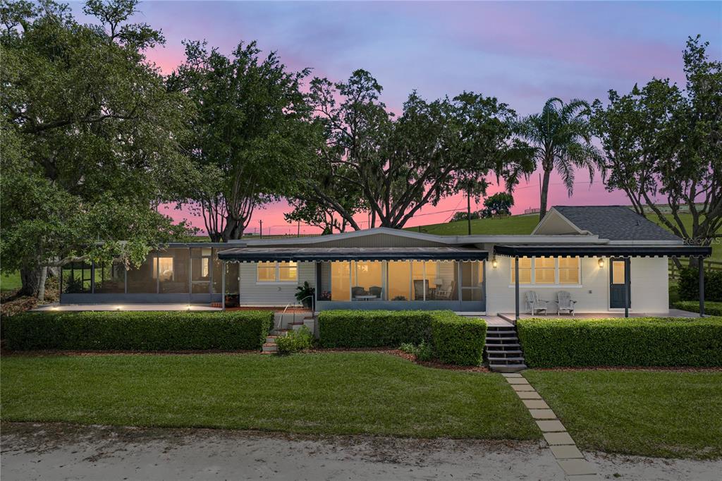 1075 Cody Cove Road Babson Park, FL 33827 - Photo 94 of 96 a front view of a house with a garden and tree