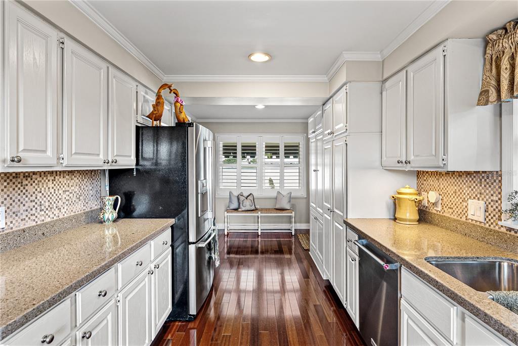 1075 Cody Cove Road Babson Park, FL 33827 - Photo 10 of 96 a kitchen with granite countertop a refrigerator and a sink