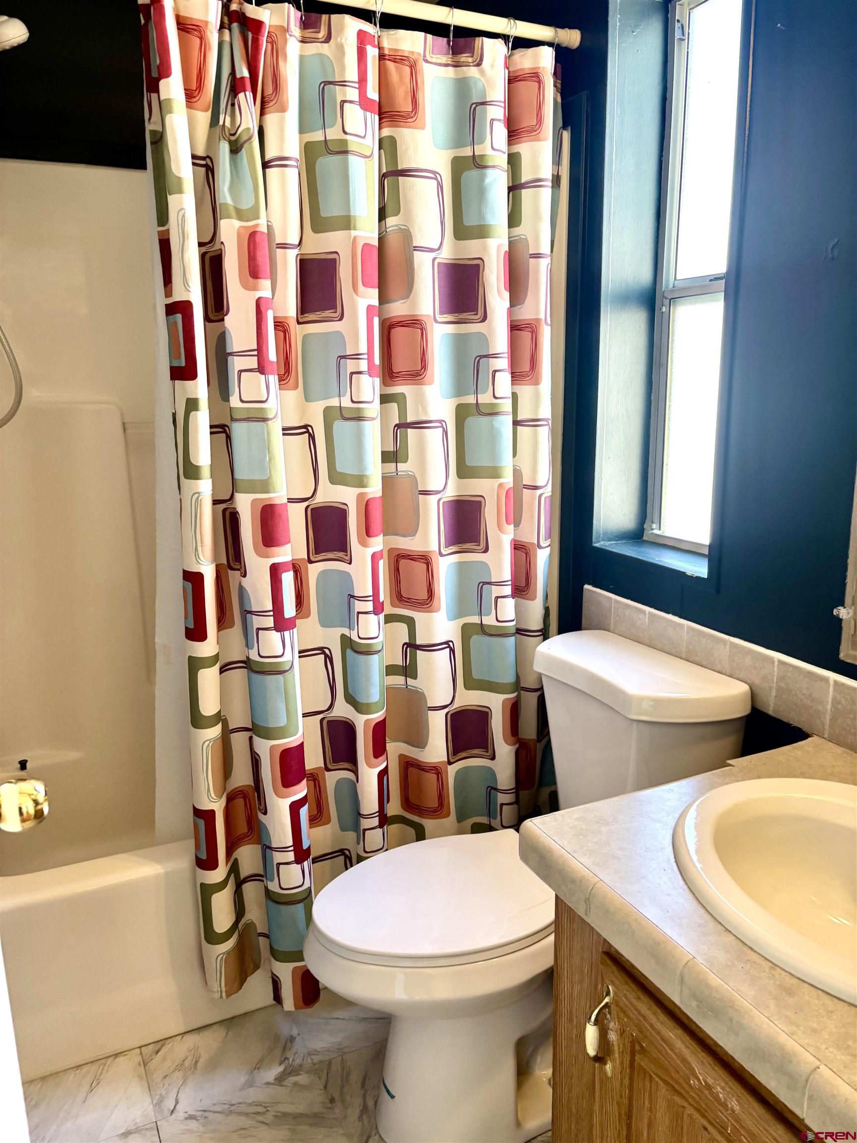 288 Animas View Drive, Unit 9 Durango, CO 81301 - Photo 11 of 16 a bathroom with a sink toilet and shower