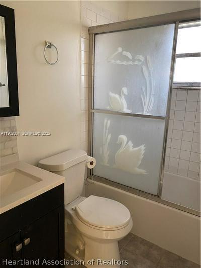 4131 Commercial Drive Sebring, FL 33870 - Photo 17 of 20 a white toilet sitting next to a bathroom sink