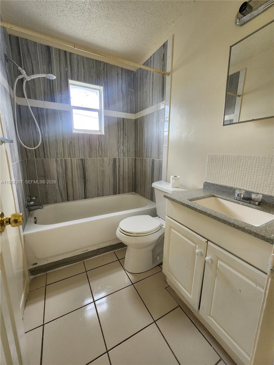 4131 Commercial Drive Sebring, FL 33870 - Photo 5 of 20 a bathroom with a sink a toilet and shower