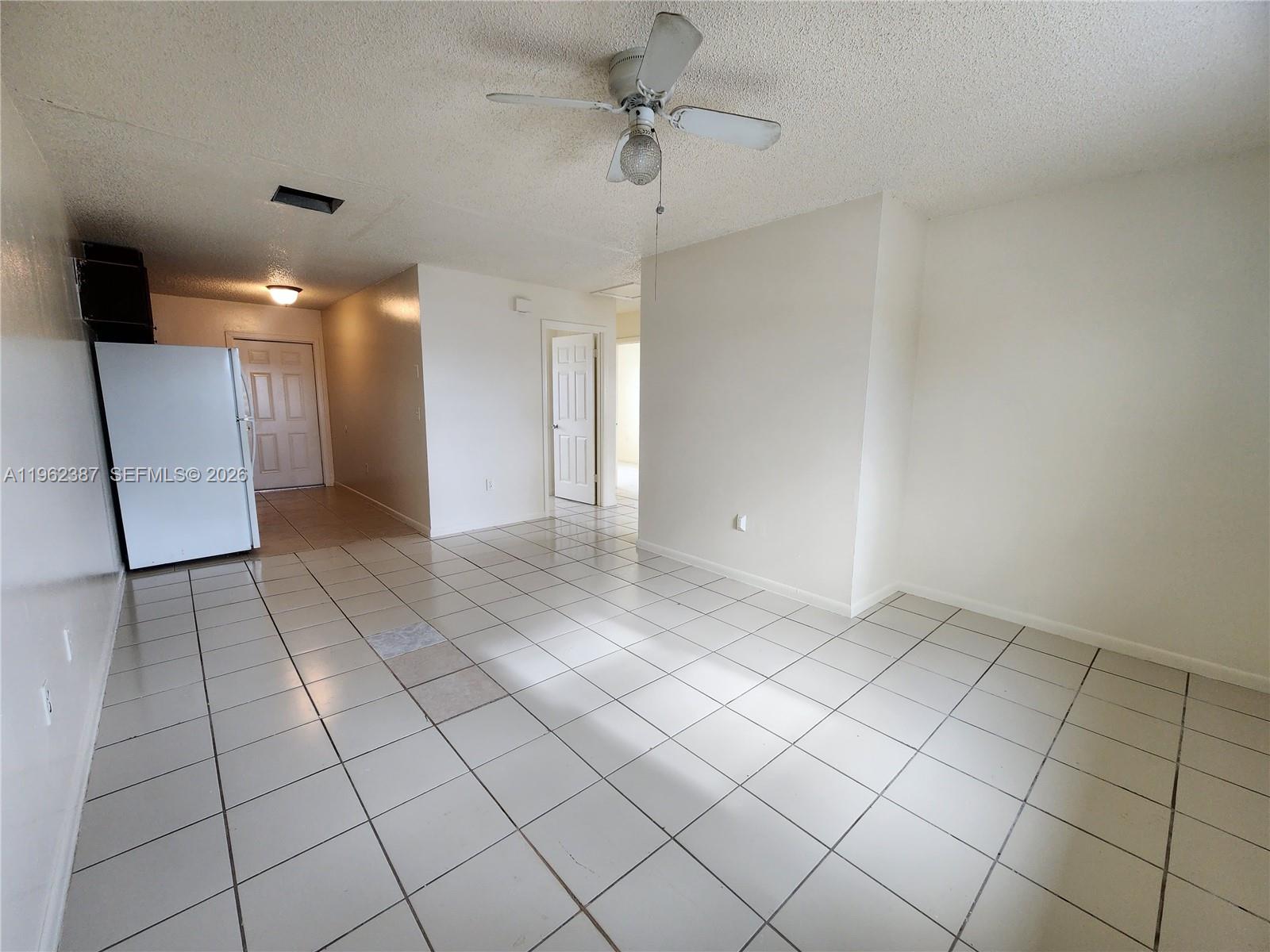 4131 Commercial Drive Sebring, FL 33870 - Photo 8 of 20 en empty room with a ceiling fan and carpet