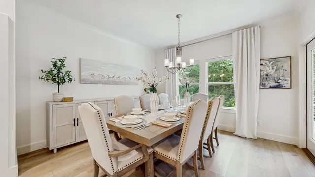 a view of a dining room with furniture window and wooden floor