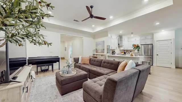 a living room with furniture and kitchen view