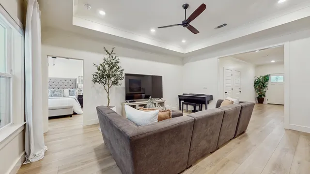 a living room with furniture a flat screen tv and a fireplace