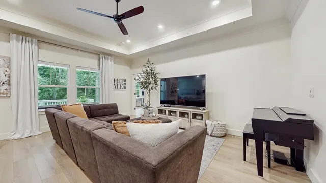 a living room with furniture and a flat screen tv
