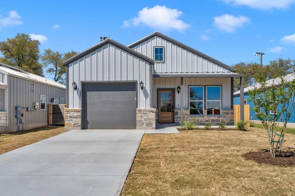a front view of a house with garden and patio